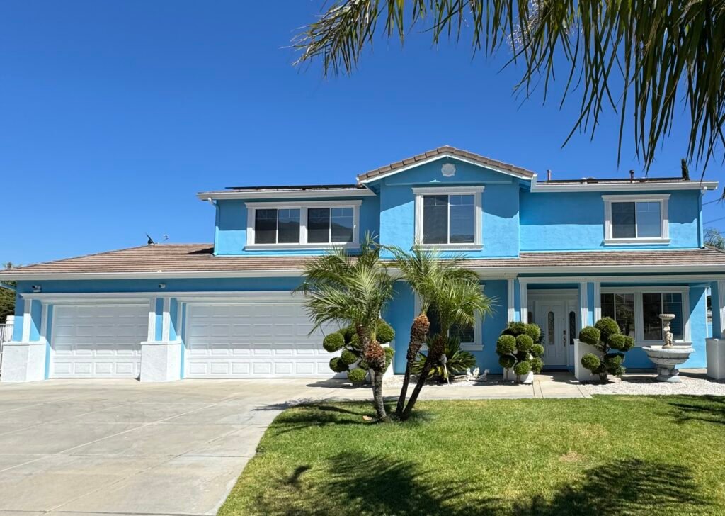 Blue two-story residential exterior painting project