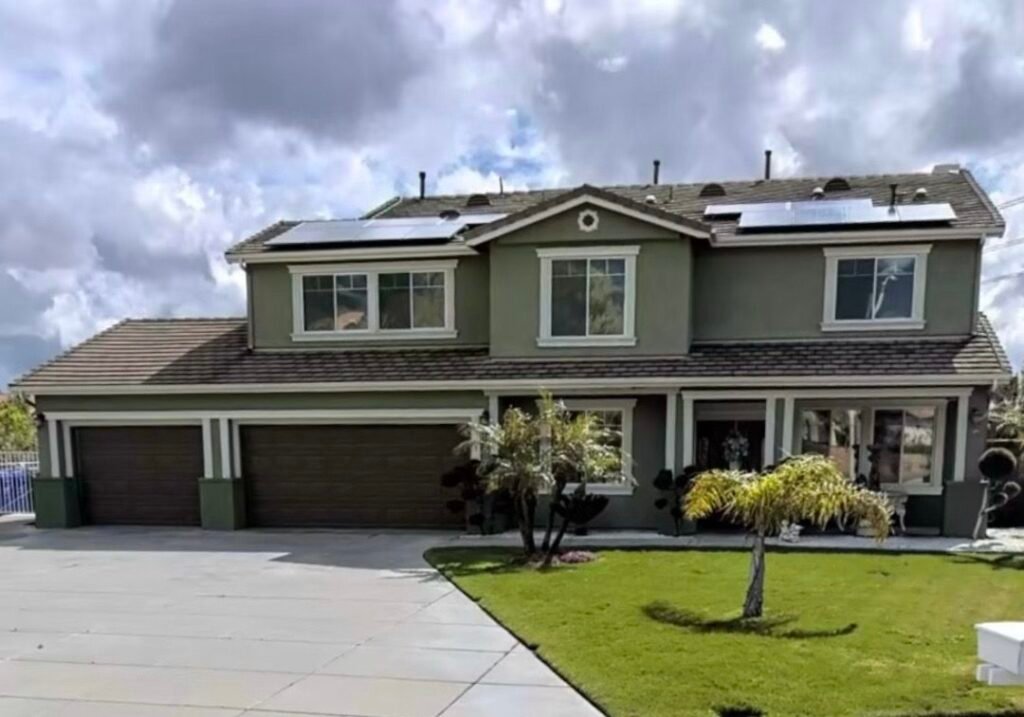 Green two-story residential exterior painting project
